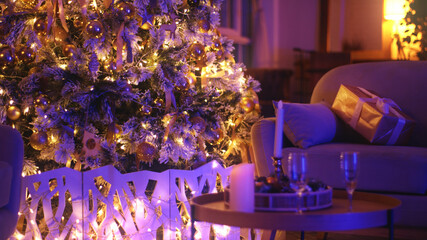 Christmas tree adorned with golden baubles and fairy lights takes center stage in a cozy living room, creating a magical and festive ambiance