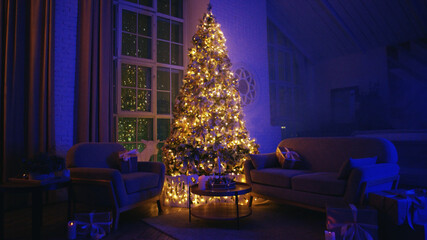 Beautifully decorated christmas tree illuminating a cozy living room with blue ambient lights at night, creating a magical and festive atmosphere