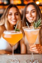 Two friends enjoy colorful cocktails at a trendy bar during a lively summer evening