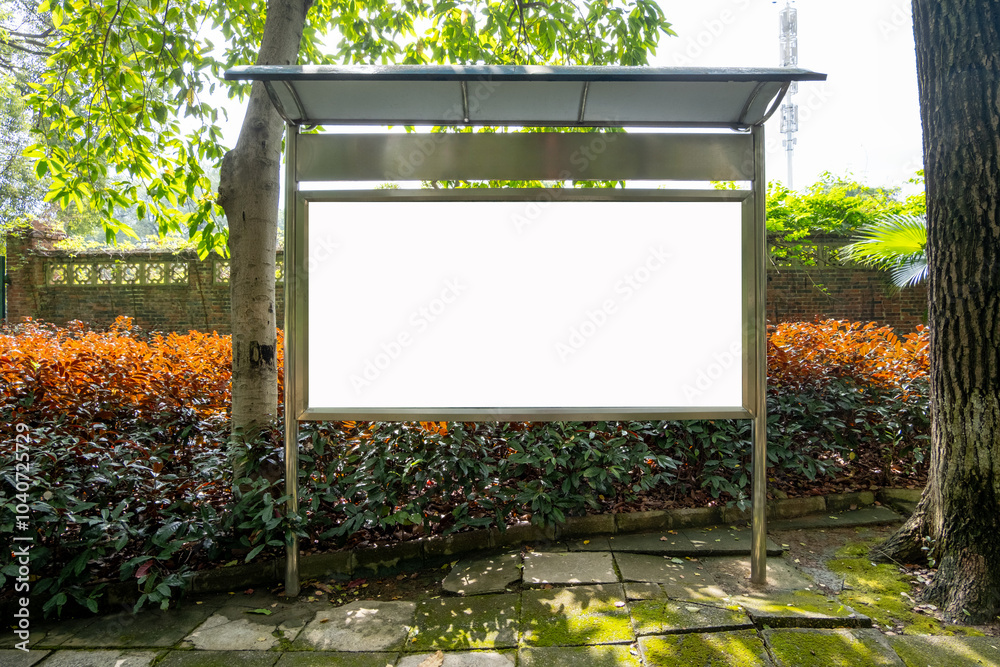 Wall mural background texture of a blank, white rectangular billboard mockup stands with a protective canopy ov
