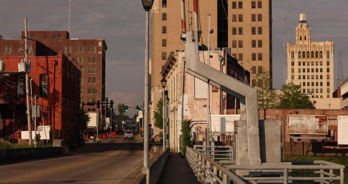 Afternoon traffic passes on a bridge into historic downtown Monroe, Louisiana, USA.