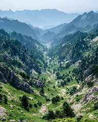 Obraz premium Breathtaking mountainous landscape with lush greenery and a vast, misty horizon, capturing the beauty of nature's rugged terrain and tranquil atmosphere.