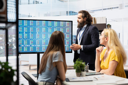 Big screen used by agent in financial department office to show stock exchange indices changing in real time. Display in empty workplace with trading indexes showing latest price modifications