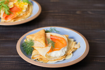 Pancake wrapped with cream cheese and smoked salmon and pankace wrapped with scrambled egg and salmon. Crepes.