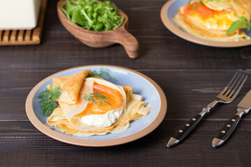 Pancake wrapped with cream cheese and smoked salmon and pankace wrapped with scrambled egg and salmon. Crepes.