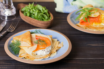 Pancake wrapped with cream cheese and smoked salmon and pankace wrapped with scrambled egg and...