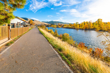 Fototapeta premium View from the Riverfront Trail along the Clark Fork River of the University District and tower of the Boone Crockett Club Natural History Museum in downtown Missoula, Montana.