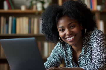 Happy African American woman engaging in a virtual meeting while working remotely from a cozy home office in a modern setting