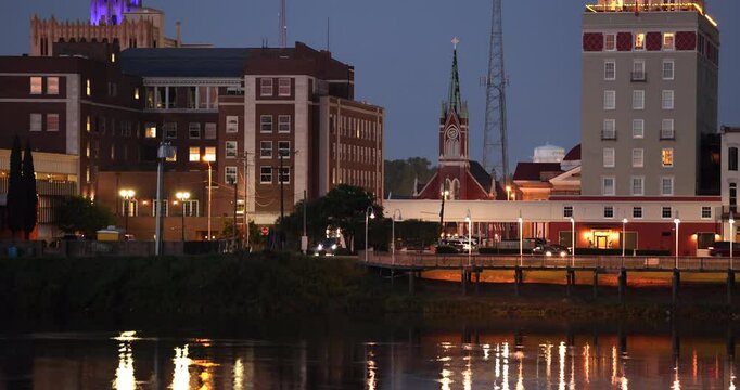Monroe, Louisiana, USA - April 4, 2024: Afternoon sunlight shines on the historic buildings and church in the skyline of downtown Monroe.