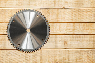 Circular Saw Blade on Wooden Plank Surface