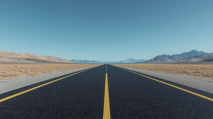 Fototapeta premium A vast, empty road stretches toward distant mountains under a clear blue sky, evoking a sense of freedom and adventure.