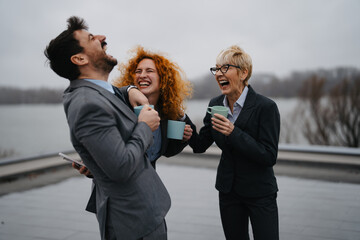 Happy business people on coffee break at rooftop