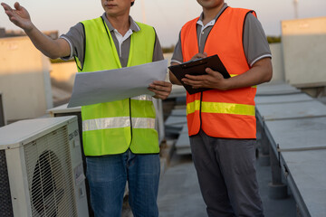 Engineers use blueprint check air condition systems on site. Contractor and inspector inspection...