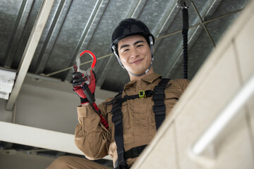 ハーネスをつける現場作業員　「高所作業もご安全に！」のポーズ