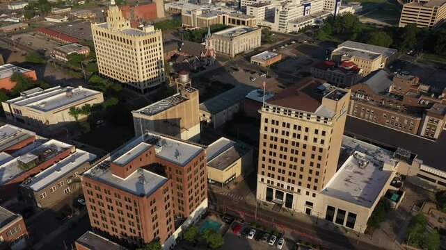 Monroe, Louisiana, USA - April 4, 2024: Afternoon sunlight shines on the historic buildings in the skyline of downtown Monroe.