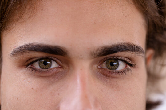 Close-up of man's green eyes gazing intently, capturing deep emotion and focus