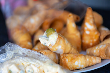 Traditional conical straws filled with mayonnaise, olives and parsley