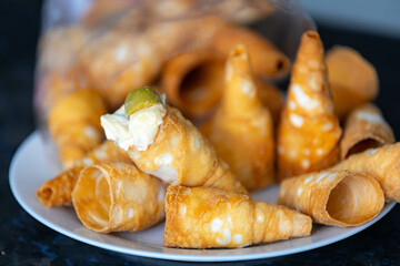 Traditional conical straws filled with mayonnaise, olives and parsley