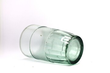 The photo shows a glass that has a frosted band around the middle and a ribbed green base.