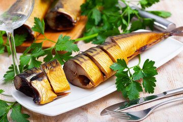 Sliced appetizing smoked mackerel with parsley closeup. High quality photo