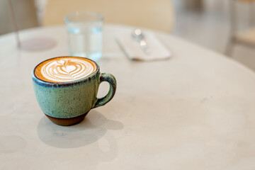 A cup of cappuccino on a table