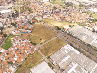 Fototapeta premium Aerial view of Industrial Building in Dwipapuri Industrial district, Rancaekek. Logistics center in industrial city zone from drone view. Background texture concept. Business and Economics