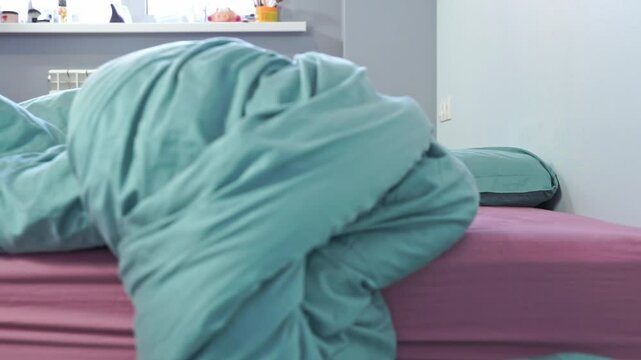 Man in pink pajamas sleeps on bed, suddenly wakes up in panic, overslept, comically falls off mattress, hurry Cheerful morning, deadline, rushing to work, being late, sleeping through the alarm clock
