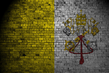 vatican flag on a brick wall.