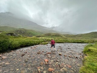 walking in a river in the highlands