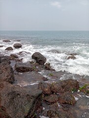 Waves crashing against the rocks on the shore