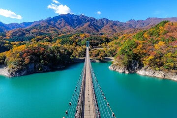 Panoramic view of a bridge over an autumn river, with colorful foliage lining both sides