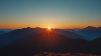 Obraz premium Sunrise Over Majestic Peaks, a breathtaking transformation of dawn light cascading over distant mountain ranges, revealing nature's beauty.