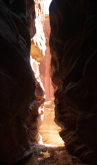 Buckskin Gulch exit with sun shines bright between narrow canyon walls 