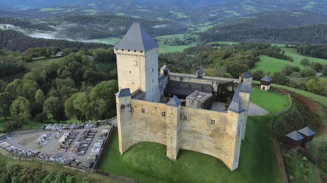 Aerial view on Mauvezin castle, a fortress with a medieval military architecture located in Occitania, France (orbital forward)