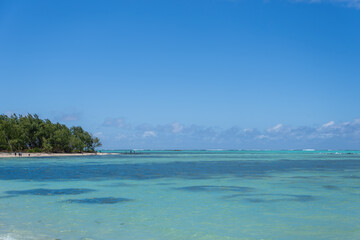 Visitors experience the thrill of paragliding in the beautiful lagoon of Ile Aux Cerfs, Mauritius. Visitors can glide effortlessly on the calm waters, surrounded by stunning scenery.