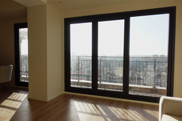 A Stylish Modern Apartment Interior Featuring Expansive Windows That Offer a Scenic View