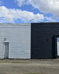 black and white building with blue sky and clouds