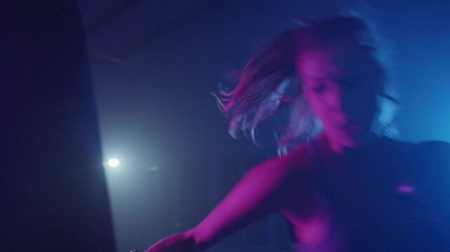 Intense boxing training session with dynamic lighting and focus on technique in a spirited gym environment