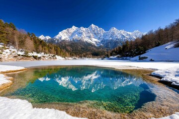 Winter banner with a frozen lake, surrounded by snow-covered mountains and frosty trees