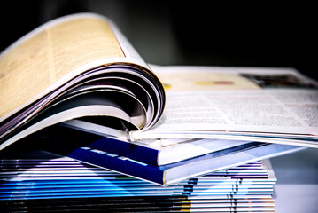 stack of books on a table, closeup photo with shallow depth of field