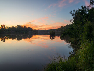 Obraz premium Sunset by the River with Reflections