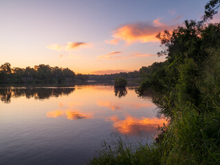 Obraz premium Sunset by the River with Reflections