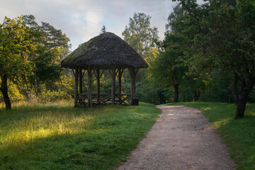 View of the ancient wooden gazebo in the apple orchard in the Mikhailovskoye Estate of the Pushkin...