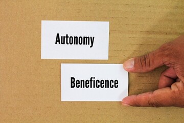 paper with the words Beneficence and Autonomy. Two important ethical principles. healthcare,...