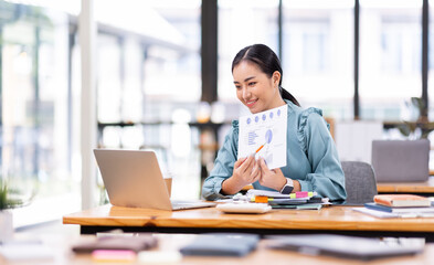 asian business woman or auditor examining documents,Professional scrutinizes financial documents...