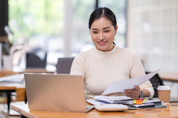 Business financing accounting banking concept. Business woman hand doing finances and calculate on desk about cost at home office. Woman working on desk with using calculator, finance accounting.
