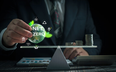 Business net zero carbon concept .Businessman hand balancing small Earth with 