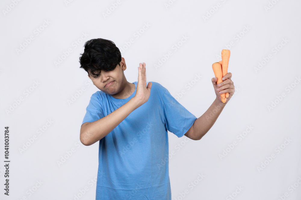 Wall mural young indomesian man who looks scared and refuses to eat vegetables, concept of healthy lifestyle, c