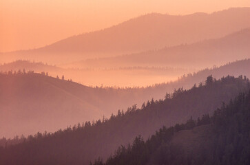 Dawn in the Southern Urals: mountain ranges in the haze from forest fires.