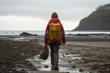Individual cleaning up litter on a coastal shoreline to preserve ocean environment